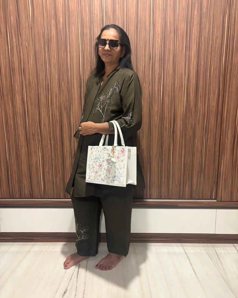 Annie wearing the floral handbag gifted by her two children for her birthday