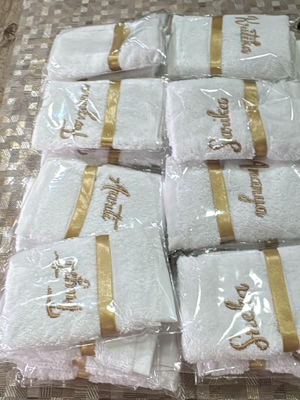 Personalised gold-embroidered name towels, hand-finished for the Saasumaa Shower